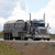16' x 27' Steel Tarp, large black steel tarp covering the back of a semi-truck on the highway.