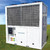 Wisperkool 30 Ton HVAC, large industrial cooling unit with metal grid front and control panel on the side, installed outdoors on grassy field.