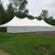 7' x 20' White Royalty Sidewall, a large white tent with sidewalls set up on a grassy area with trees in the background.