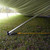7-inch Raize It! Plate, close-up view of a white 7-inch plate under a tent or canopy on grass, used for outdoor events or activities.