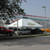 Celina Tent 20' x 30' Classic Series Pole Tent, 1 Piece Tent Top, Complete, shown set up outdoors on a parking lot with various vehicles and trees.
