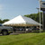 Celina Tent 20' x 40' Classic Series Pole Tent, 1 Piece Tent Top, Complete, large white outdoor tent set up on grass with supporting poles and open sides at a parking lot event.