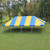 Celina Tent 20' x 40' Classic Series Pole Tent, 1 Piece Tent Top, Complete, with yellow and blue striped canopy set up on a grassy field.