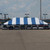 Celina Tent 30' x 60' Classic Series Pole Tent, Sectional Tent Top, Complete, blue and white striped outdoor event tent set up in a parking lot