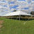Celina Tent 40' x 100' Classic Series Pole Tent, sectional tent top with a white canopy set up outdoors on grass.