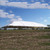 Celina Tent 60' x 100' Classic Series Pole Tent, Sectional Tent Top, Complete, in outdoor setting with blue sky and clouds.