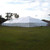 Celina Tent 80' x 100' Classic Series Pole Tent, Sectional Tent Top, Complete, large white outdoor event tent set up on grassy area.