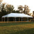 Celina Tent 20' x 40' Master Series Frame Tent, 1 Piece Tent Top, Complete, white outdoor event tent set up on grass at sunset with trees in the background.