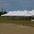 20' x 50' Premiere I Series High Peak Pole Tent, Sectional Tent Top, Complete, outdoor event tent with high peaked white fabric roof and support poles on a grassy field.