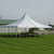 Celina Tent 30' x 30' Premiere I Series High Peak Pole Tent, Sectional Tent Top, Complete, white high peak pole tent set up on grass with guy lines and stakes in an outdoor event space.