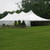 Celina Tent 40' x 100' Premiere I Series High Peak Pole Tent, Sectional Tent Top, Complete, outdoor event tent set up on grassy area with trees in background.