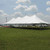 Celina Tent 40' x 100' Premiere I Series High Peak Pole Tent, Sectional Tent Top, Complete, set up on a green field under a partly cloudy sky, showcasing its large size and sturdy structure with multiple peaks and support poles.