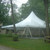 Celina Tent 40' x 40' Premiere I Series High Peak Pole Tent, Sectional Tent Top, Complete, installed outdoors among trees on a grassy area with a picnic table nearby.