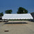 20' x 30' Classic Series Gable End Frame Tent, 1 Piece Tent Top, Complete, outdoor event tent with white fabric cover and metal frame on paved surface under blue sky.