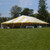 Celina Tent 40' x 80' Classic Series Frame Tent, Sectional Tent Top, Complete, large white and yellow striped outdoor event tent set up on a grassy field with trees in the background.