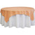 54'' X 54'' Cherry Polyester Tablecloth, image showing a round table covered with a cherry-colored polyester tablecloth layered over a white tablecloth.