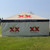7' x 20' Royalty SW Logo Print, outdoor promotional canopy tent with Dos Equis logo and branding, set up on grassy area under clear sky.