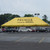 Celina Tent 20' x 40' Classic Series Pole Tent Full Digital Print, Complete, yellow event tent with 'PREMIER CAR RENTAL' branding, set up in a parking lot with cars and trees in the background.
