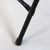 Bellbrook Black Chair, close-up of the chair's black metal leg with a protective rubber foot on a white background.