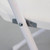 Bellbrook White Chair, close-up of the metallic support bracket and white leg of the chair.
