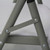 Mayfield Chair and Round Resin Table Set, close-up of the chair's gray metal leg structure with bolts connecting the parts.