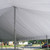 20' x 30' Classic Pole Tent Liner, white fabric tent liner draped over the interior of a large outdoor tent with metal poles and a view of a suburban street outside.