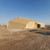 4K Dome Shelter, large beige outdoor tent with a dome shape, situated in a desert environment under a clear blue sky.