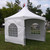 Weekend Warrior Starter Bundle, a white outdoor event tent with windowed panels set up on green grass under a partly cloudy sky.