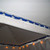 20' - White Vinyl Water Gutter, installed under a tent ceiling with hooks and brackets for water drainage