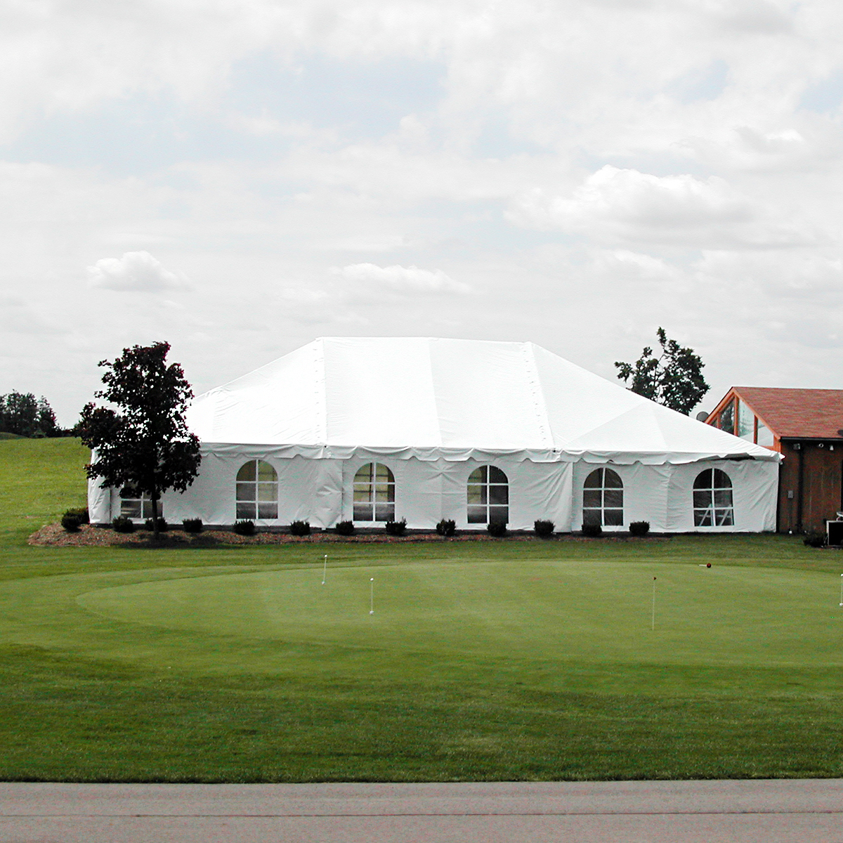 Elegant wedding tent decorated with drapes and chandeliers