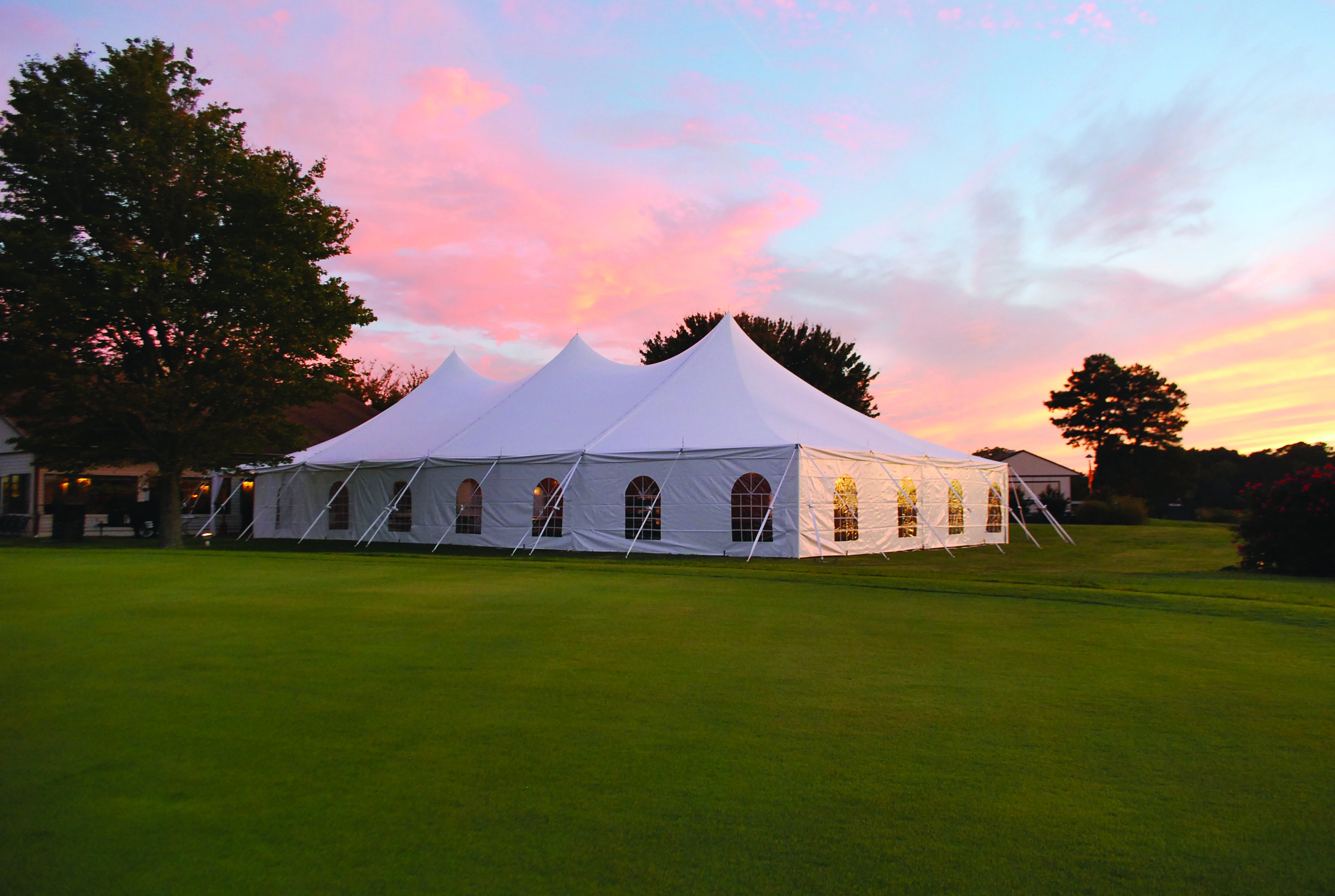 Decorated graduation party tent with tables and lights