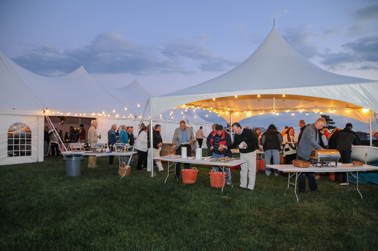 Wedding tent setup for an outdoor reception showing space for seating, walkways, and lighting considerations
