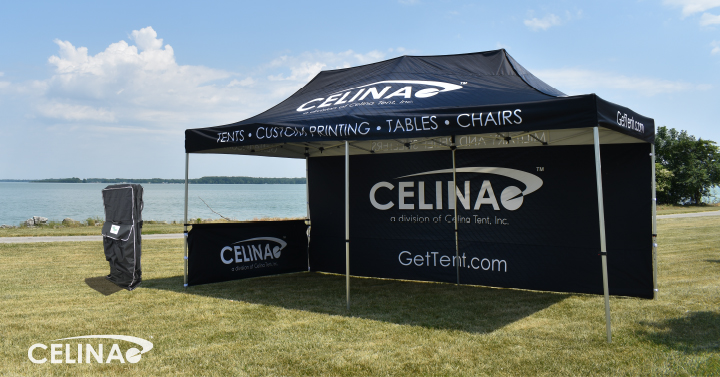 Custom pop up tent with branded canopy at a professional outdoor event setup