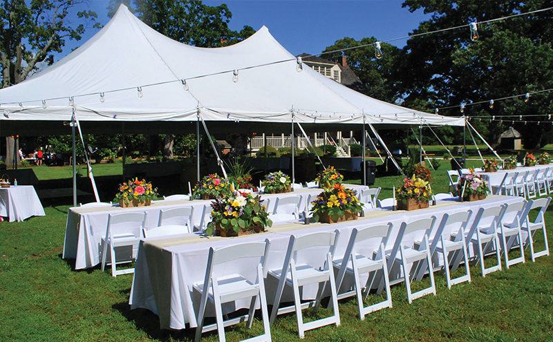 Outdoor wedding tent setup with elegant décor
