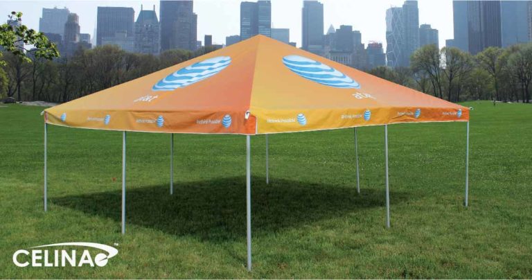 Custom branded business tent set up at an outdoor event with logo on canopy and sidewalls
