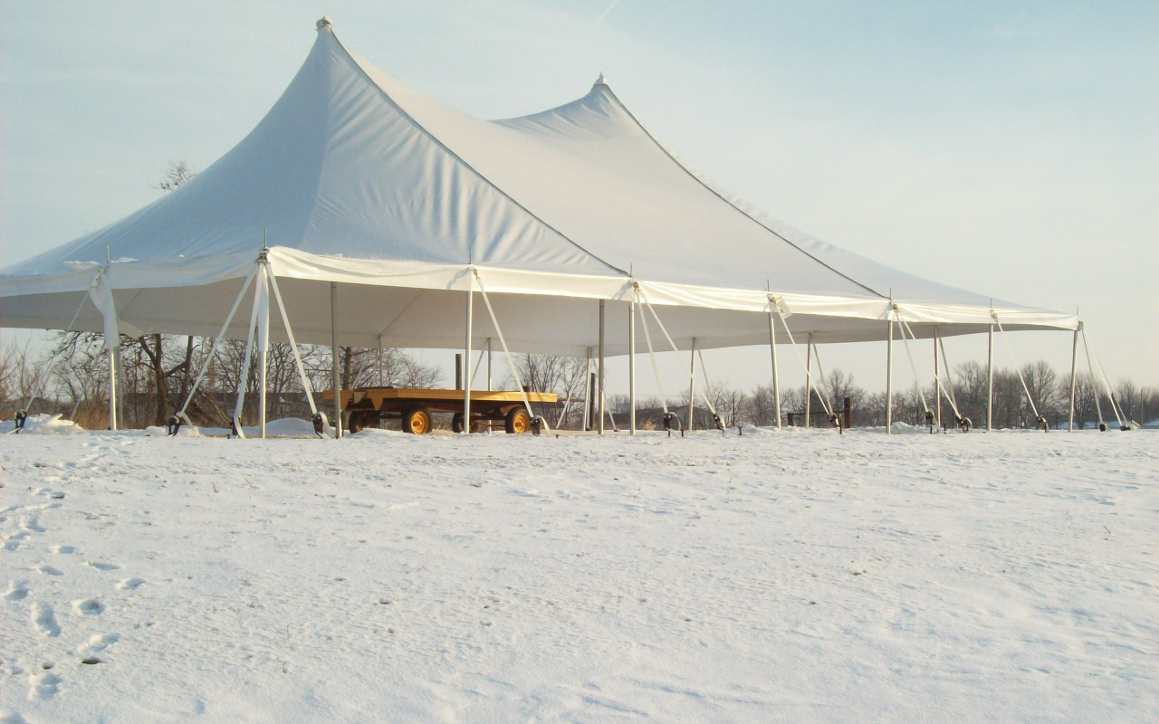 Traditional pole party tent with high peaks at outdoor wedding