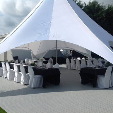 Tent flooring system installed under event seating