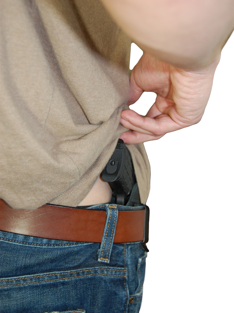 Man wearing a handgun in a clip on webbing holster tucked into the waistband  of his pants in a close up side view Stock Photo - Alamy