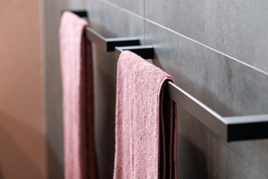 Pair of black towel bars decorated with towels