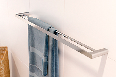 Double towel bar with blue towel hanging