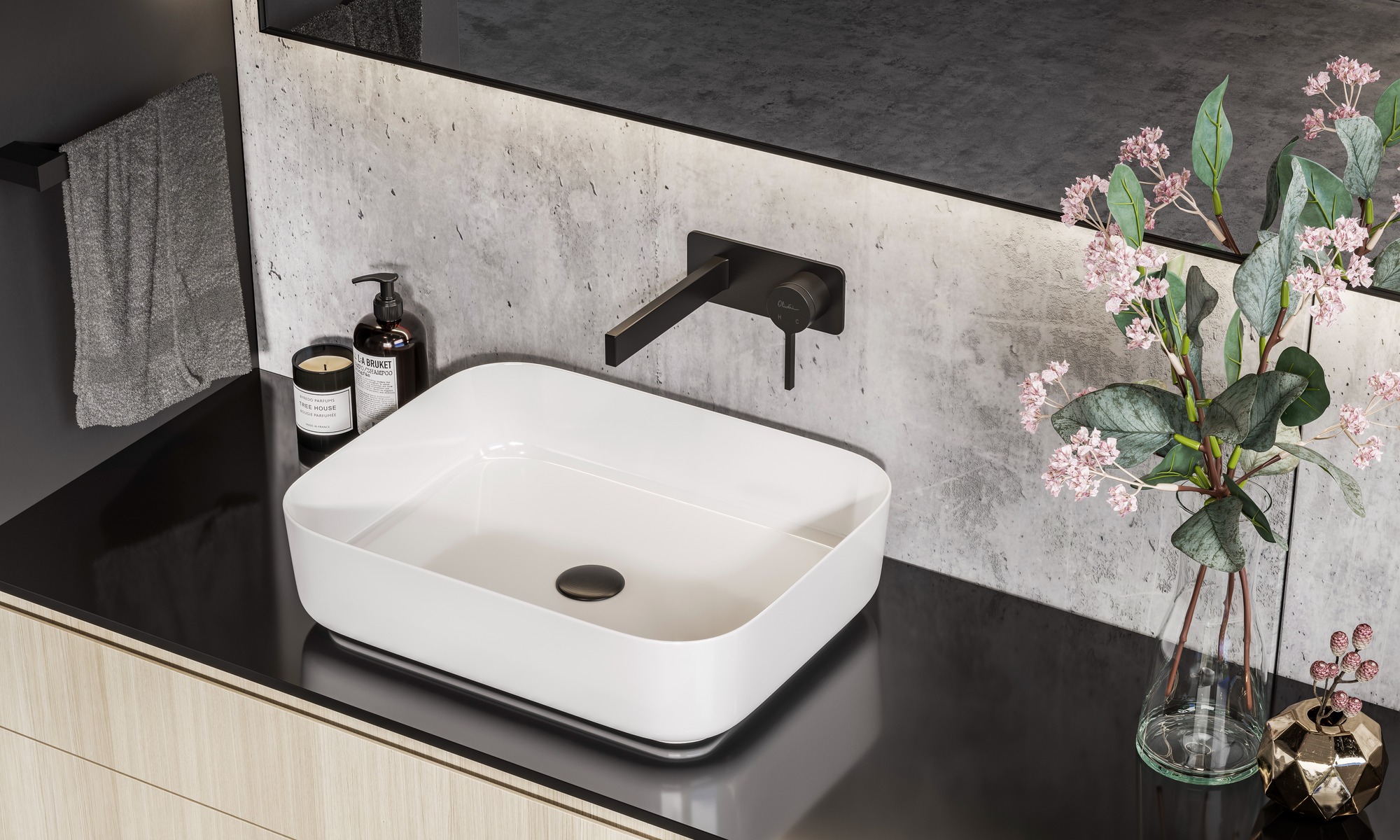 Rectangular white bathroom basin on black counter with black wall mounted basin mixer