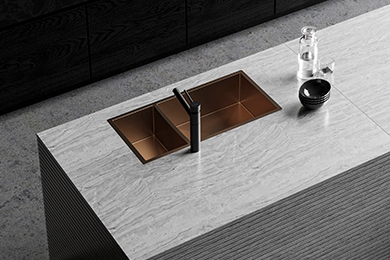 Double bowl kitchen sink with tap, set on a sleek grey tiled countertop