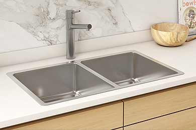 Double square bowl kitchen sink tap installed on a white countertop