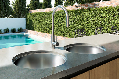 Double-rounded bowl kitchen sink with tap in an outdoor setting