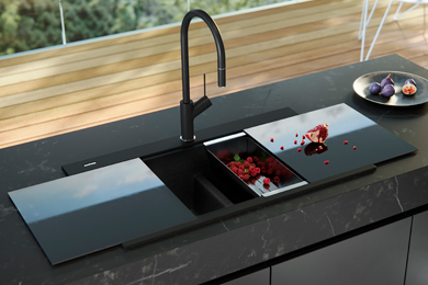 Black double bowl kitchen sink with tap and cover in an outdoor setting