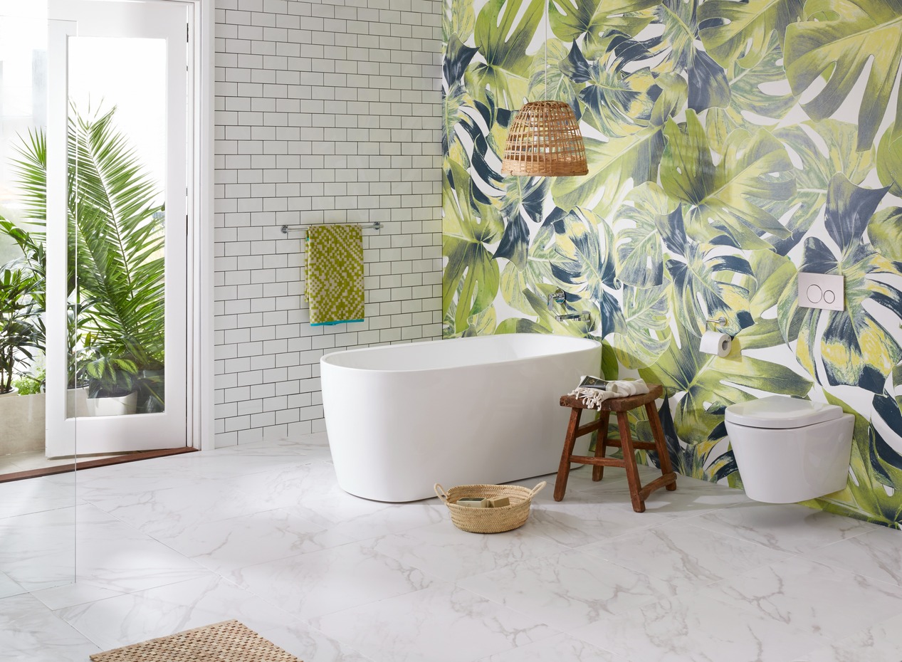 Bathroom with floral wall, white bathtub and white toilet