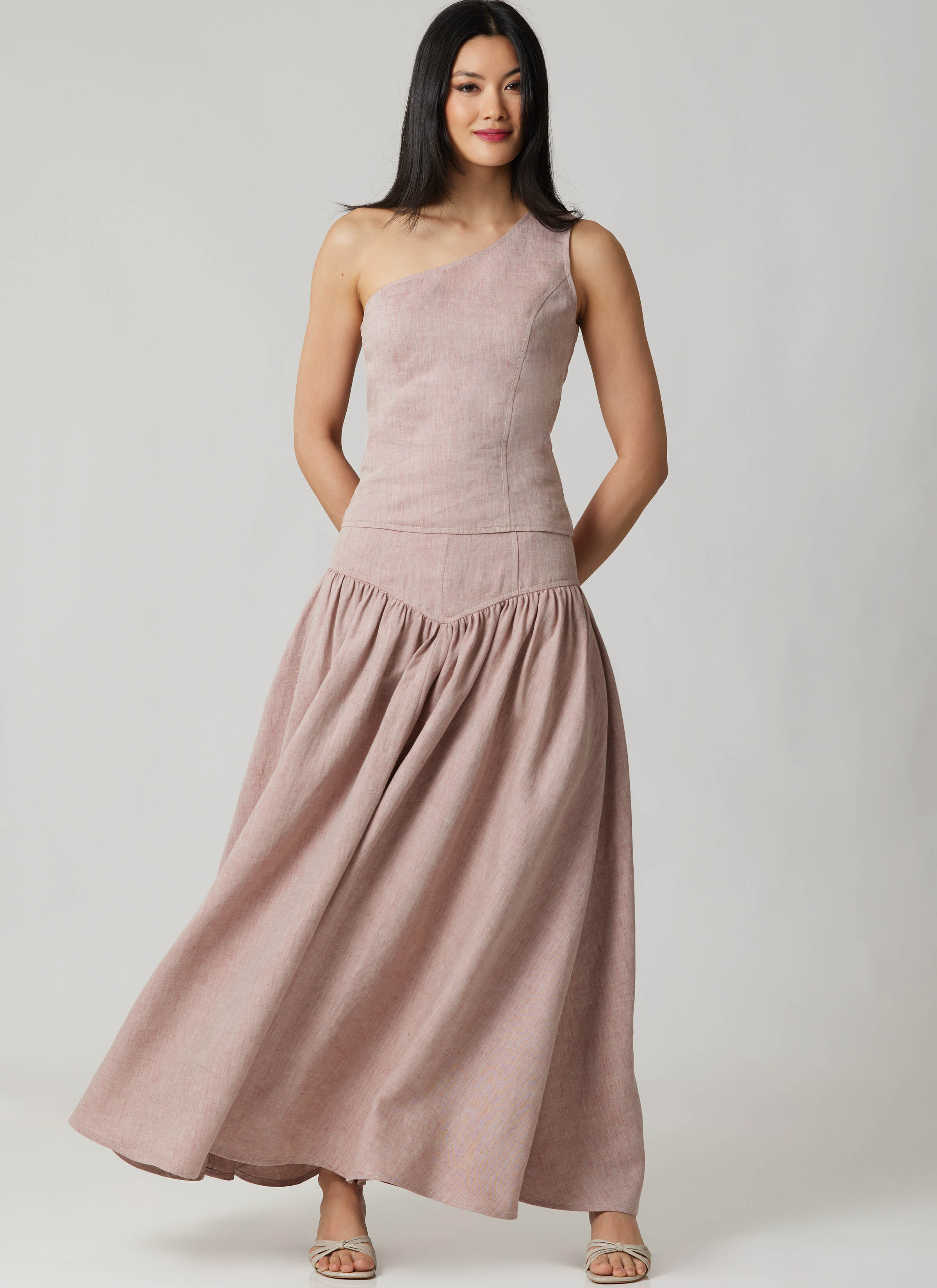 M8683 - Woman wearing pale pink one shoulder top with matching skirt.