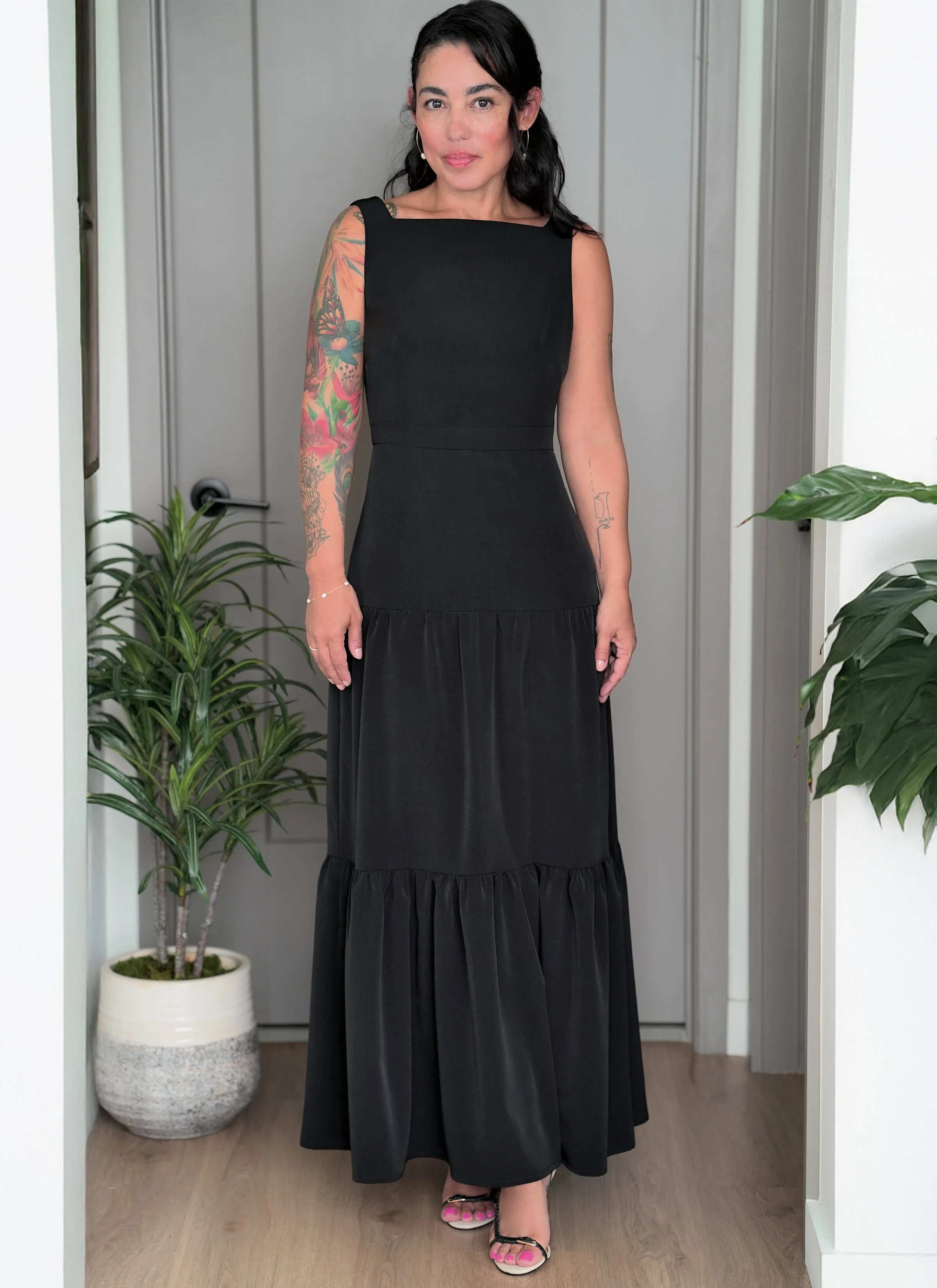 Woman wearing black maxi dress with tiered skirt