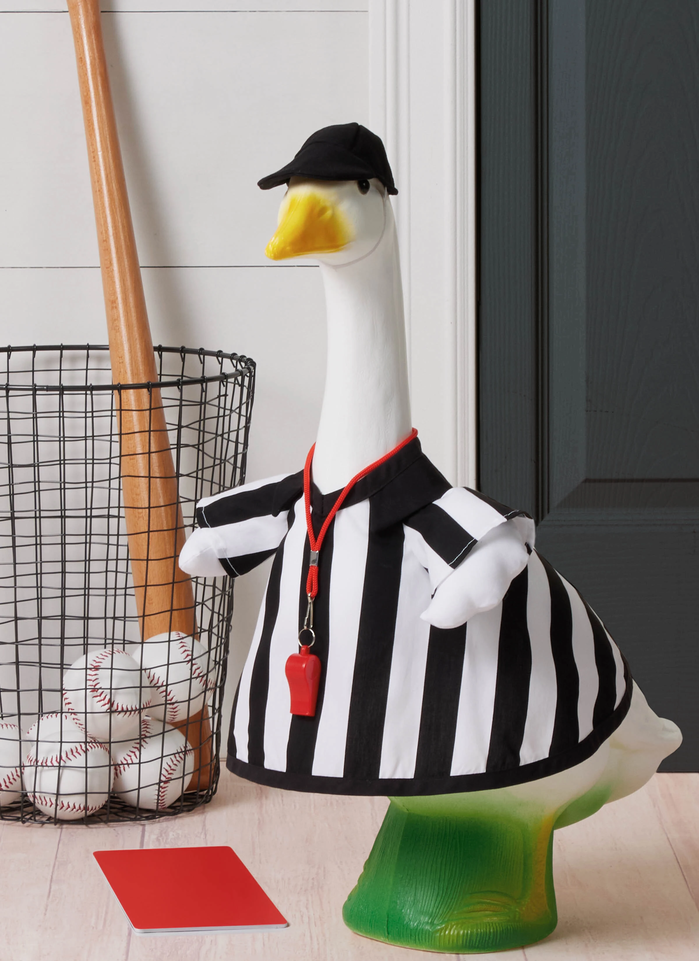 Porch goose wearing referee shirt and black hat.