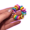Dinky Things Fidgets - Rainbow Ring is an eye-catching fidget adorned with a kaleidoscope of smooth rainbow beads that effortlessly glide along your fingers.